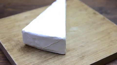 French cheese on a chopping board Stock Footage 94540705