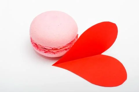 French colorful macarons with red paper heart on white background Stock Photos