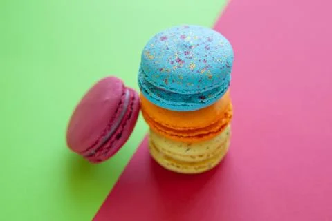 French crash macarons. Stack of colorful macaroon on green and red background Stock Photos