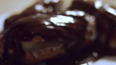 French dessert- chocolate eclair. Macro view of chocolate eclairs. 4k video Stock Footage 144734499
