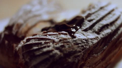French dessert- chocolate eclair. Pouring melted chocolate on eclairs. 4k video Stock Footage 144733361