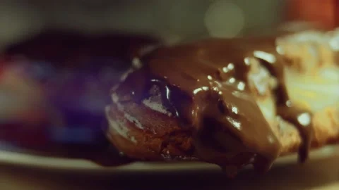 French dessert chocolate eclair. Pouring melted chocolate on eclairs Stock Footage 238994623