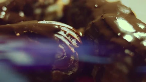 French dessert chocolate eclair. Pouring melted chocolate on eclairs Stock Footage 238994686
