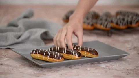 French dessert eclair with chocolate and custard. Traditional French dessert. Stock Footage 161146906