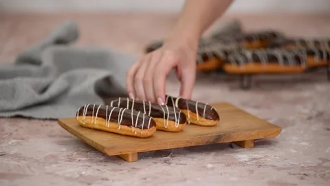 French dessert eclair with chocolate and custard. Traditional French dessert. Stock Footage 163550912