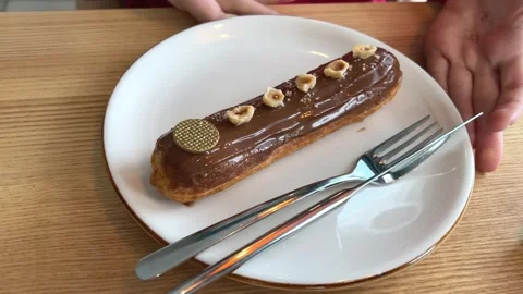 French dessert eclair, with dark chocolate glaze, chocolate glaze dripping from Stock Footage 264717627