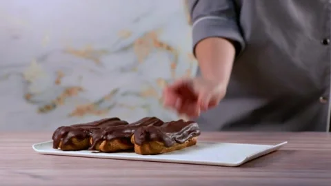 French dessert eclair with dark chocolate glaze. Stock Footage 267022855