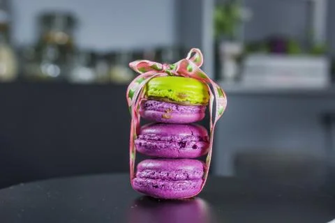 French dessert, three macarons lined up hardly tied with a beautiful ribbon, two Stock Photos