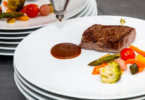 French dish breaded beef with vegetables watered with sauce Stock Photos