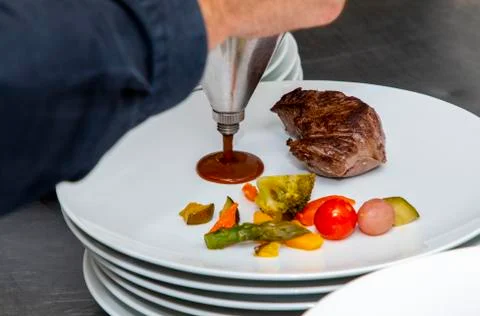 French dish breaded beef with vegetables watered with sauce Stock Photos