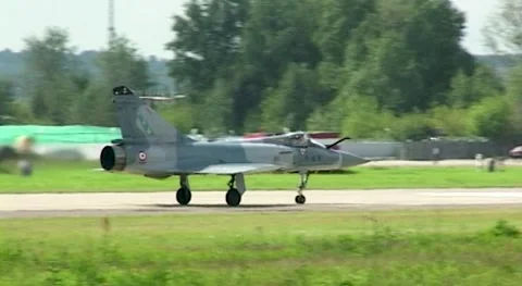French fighter Dassault Mirage 2000 moves along runway towards parking lot. Stock Footage 195472131