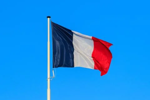 The french flag with blue sky in the background Stock Photos