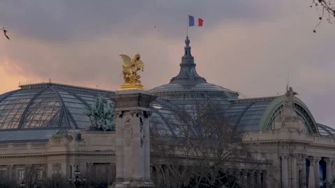 French flag floating over the glass roof of the Grand Palais in Paris Stock Footage 305582651