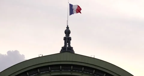 French flag floating over the roof of the Grand Palais, Paris, France time lapse Stock Footage 245457635