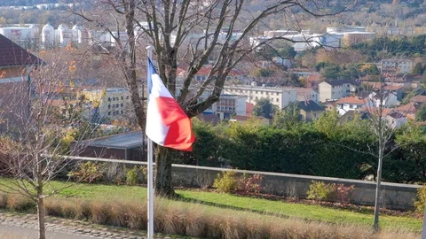 French flag fluttering and blowing by wind with Lyon city in far back Stock Footage 99767073