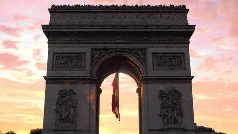 The French flag flutters in the Arc de Triomphe at sunset, Paris Stock Footage 205550229