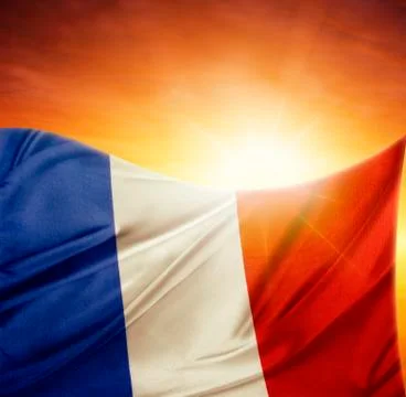 French flag in front of bright sky Stock Photos