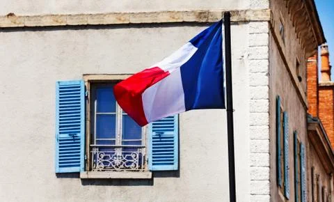 French flag over classical generic France window Stock Photos