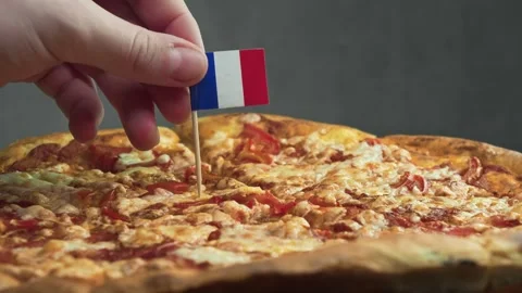 French flag placed into slice of cheese pizza, symbol of French gourmet approach Stock Footage 323397368