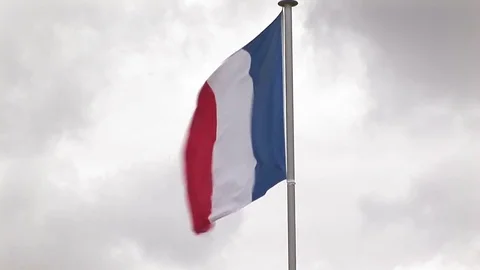 French Flag in strong wind Juno Beach, Normandy France Stock Footage 83105313