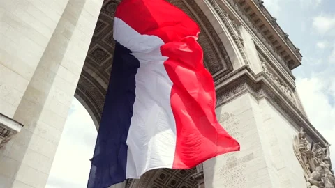 French flag under Arc de Triomphe with blue sky in Paris, France 06.08.2025 Stock Footage 311060208