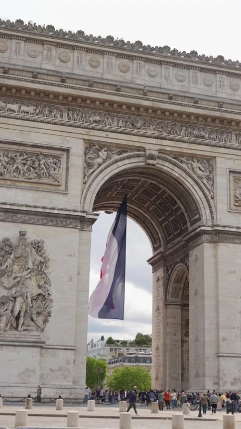 French flag under Arc de Triomphe with tourists in Paris, France 06.08.2025 Stock Footage 311064107