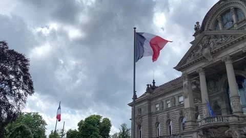 French flag waving against cloudy sky, Strasbourg, France Vidéo 277546315