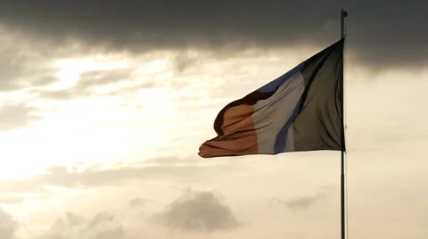 French flag waving in front of a sunset in slow motion Stock Footage 65826729