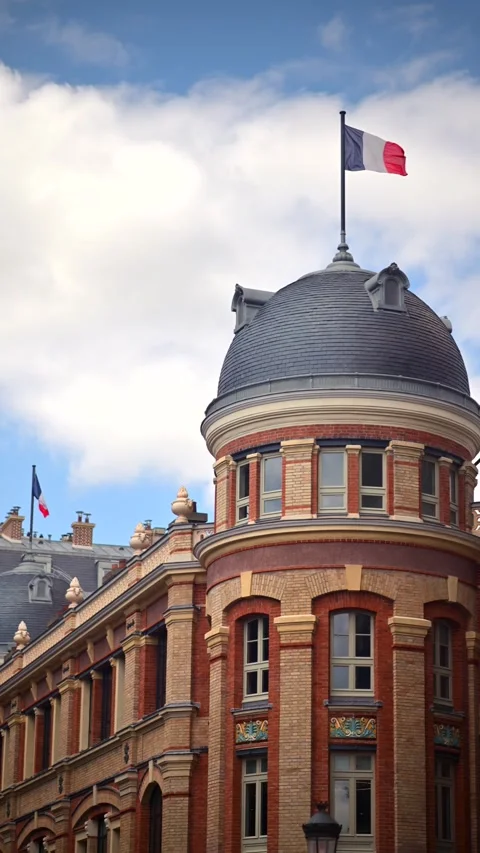 French flag waving gently atop a historic Parisian building with classic ar.. Stock Footage 339470756