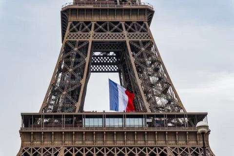 French flag waving in the middle of the Eiffel Tower during coronavirus lockdown Stock Photos