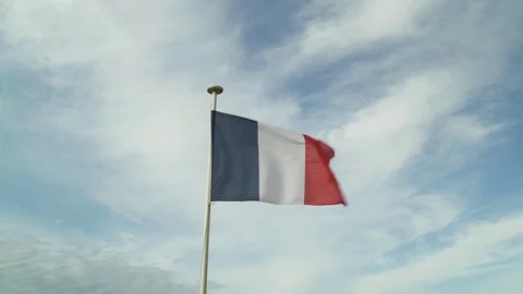 French flag in the wind in cloudy blue sky in Deauville Beach, France. Birds and Stock-Footage 119344587