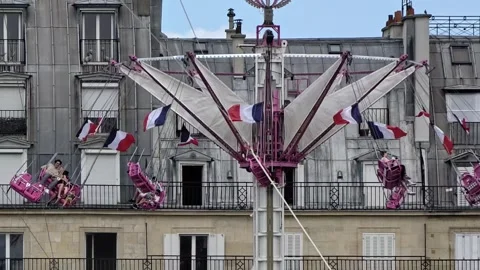 French Flags Flying Around The Amusement Park Rides At Fete Des Tuileries In Stock-Footage 343334121