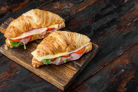 French food for breakfast. Baked Croissant sandwich with ham greens and chees Stock Photos