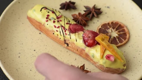 French food, dessert eclair with chocolate filling. Eclair as a background Stock Footage 310882856