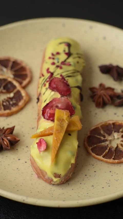 French food, dessert eclair with chocolate filling. Eclair as a background Stock Footage 310882860