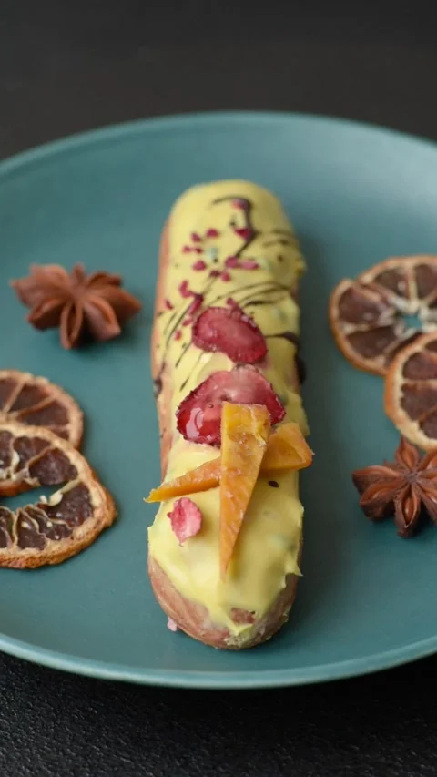 French food, dessert eclair with chocolate filling. Eclair as a background Stock Footage 310882861