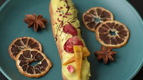 French food, dessert eclair with chocolate filling. Eclair as a background Stock Footage 310882863