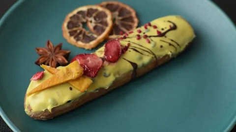French food, dessert eclair with chocolate filling. Eclair as a background Stock Footage 310882864