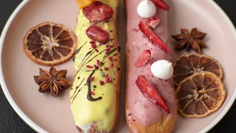 French food, dessert eclair with chocolate filling. Eclair as a background Stock Footage 310882866