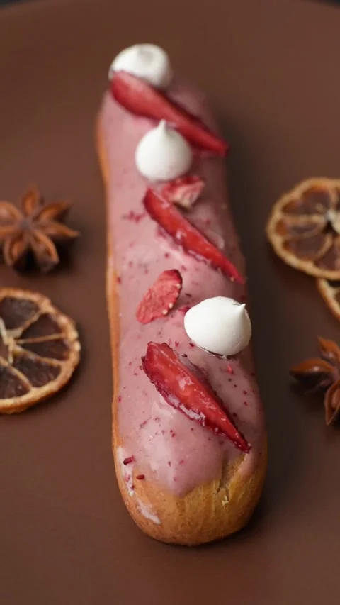 French food, dessert eclair with chocolate filling. Eclair as a background Stock Footage 310882870