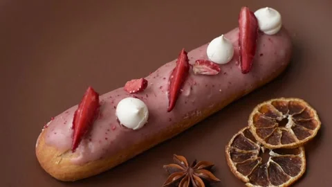 French food, dessert eclair with chocolate filling. Eclair as a background Stock Footage 310882874