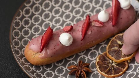 French food, dessert eclair with chocolate filling. Eclair as a background Stock Footage 310882878