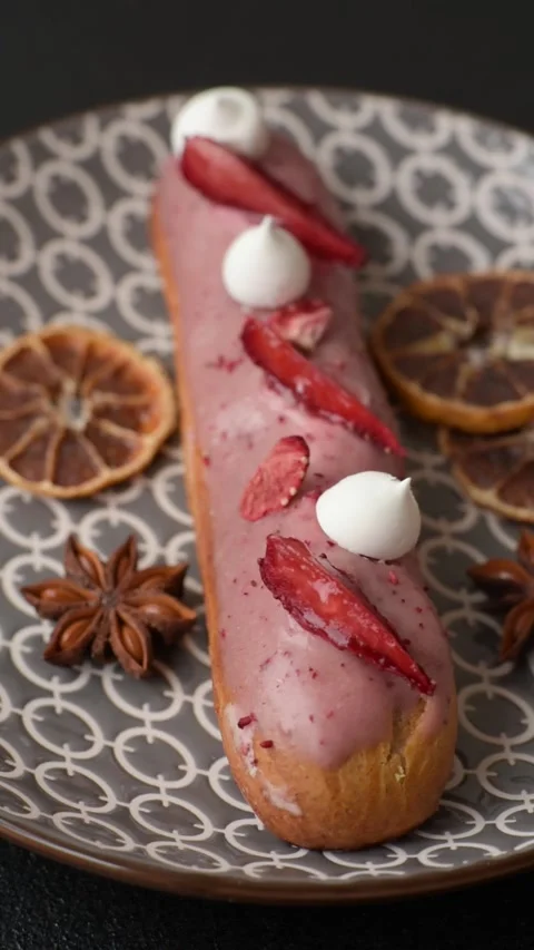 French food, dessert eclair with chocolate filling. Eclair as a background Stock Footage 310882880