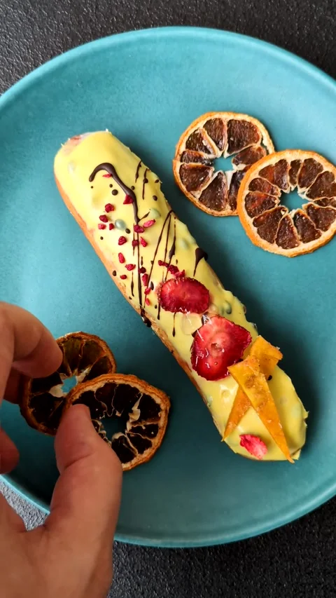 French food, dessert eclair with chocolate filling. Eclair as a background Stock Footage 310882895