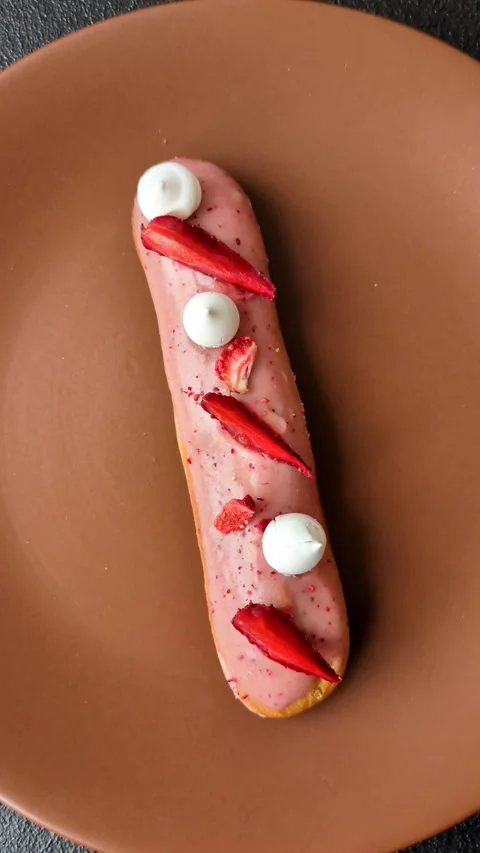 French food, dessert eclair with chocolate filling. Eclair as a background Stock Footage 310882904