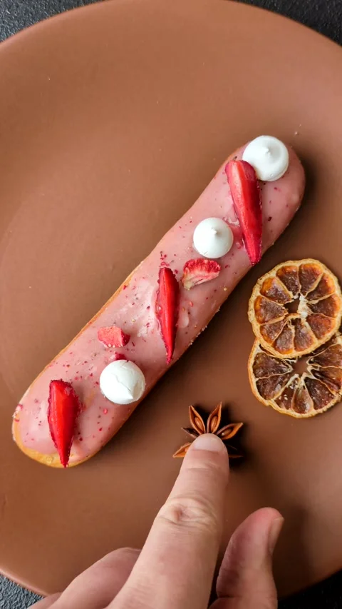 French food, dessert eclair with chocolate filling. Eclair as a background Stock Footage 310882905