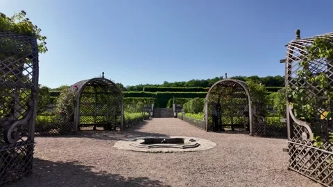 French formal gardens with geometric hedges and ornamental plantings at Château Stock Footage 338317406