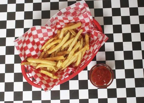 French Fried Potatoes in Retro Cafe With Checkered Paper Stock Photos