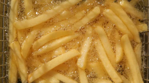 French fries are deep fried at fast food restaurant Stock Footage