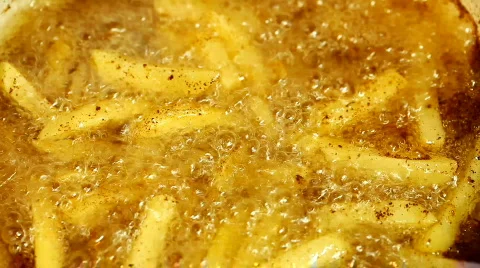 French fries cooking in oil Stock Footage